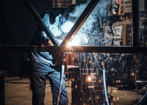 Operatore al lavoro su una lavorazione di carpenteria Milano per la realizzazione di componenti metallici su misura.